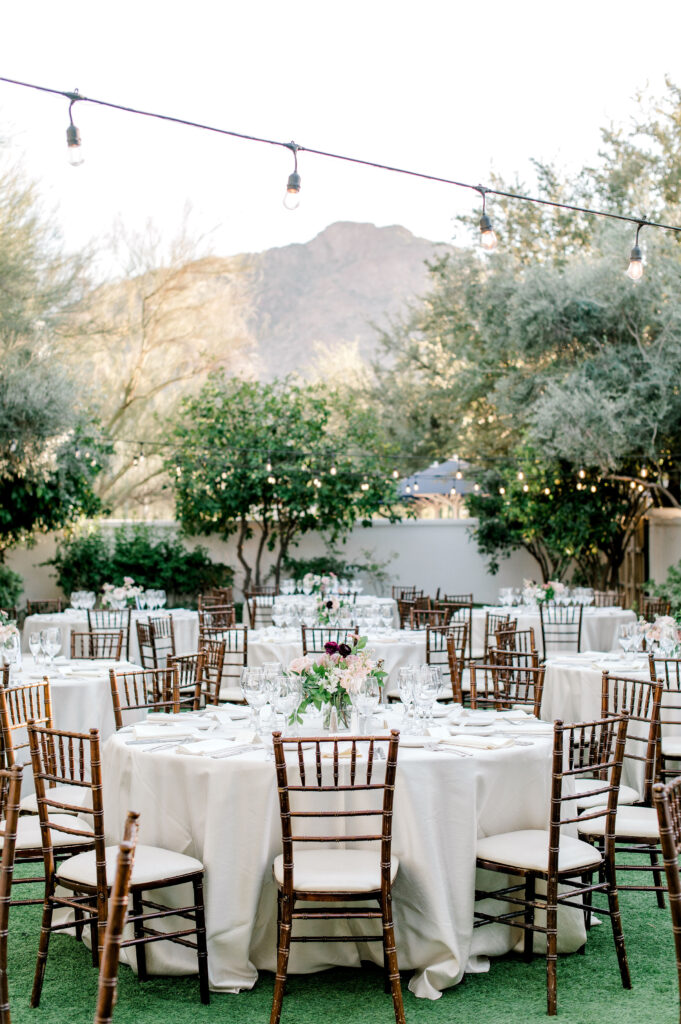 El Chorro outdoor reception of round tables with white linens and reception centerpieces.