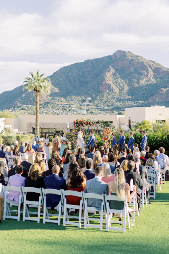 Outdoor wedding ceremony at Camelback Inn with mountain in distance.