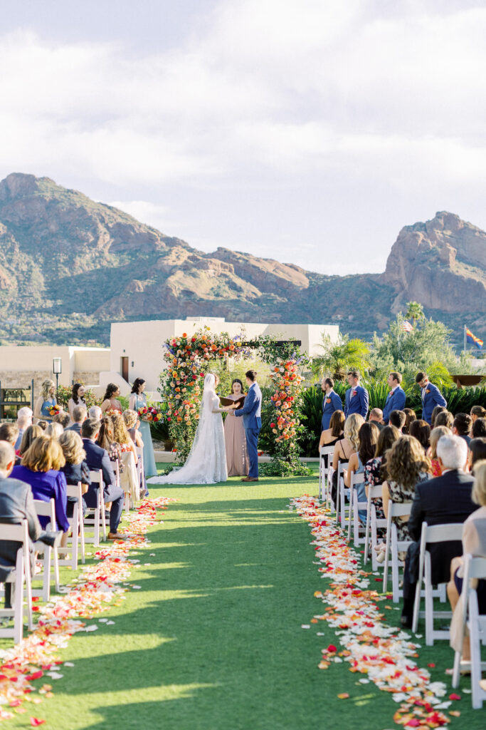 Bride and groom at front of ceremony altar space at Camelback Inn during wedding ceremony.