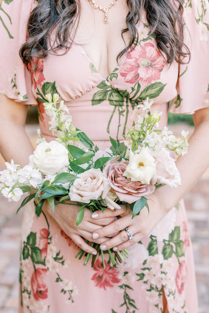 Bridesmaid bouquet of white and pink flowers with greenery.