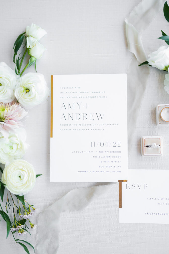 White and gold wedding invitation flatlay.