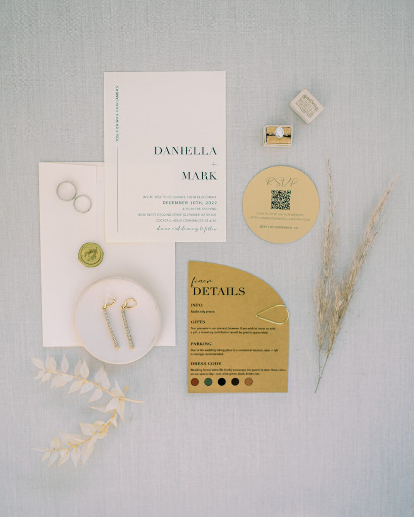 Wedding invitation flat lay of white and gold colors.