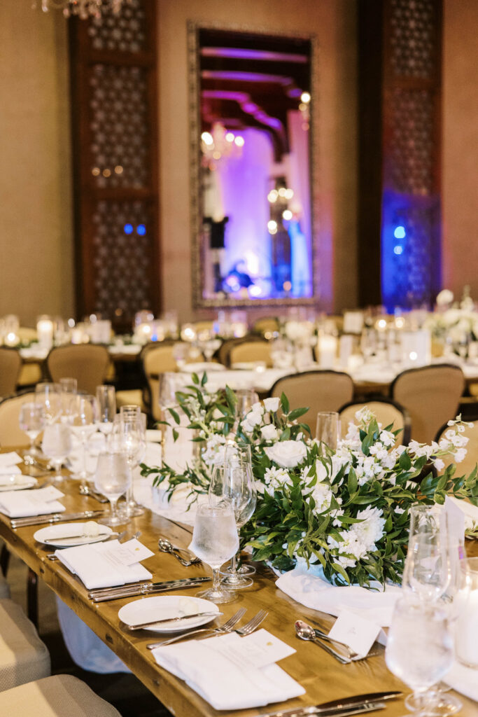 Indoor reception space at Omni Montelucia with white flowers and greenery centerpieces.