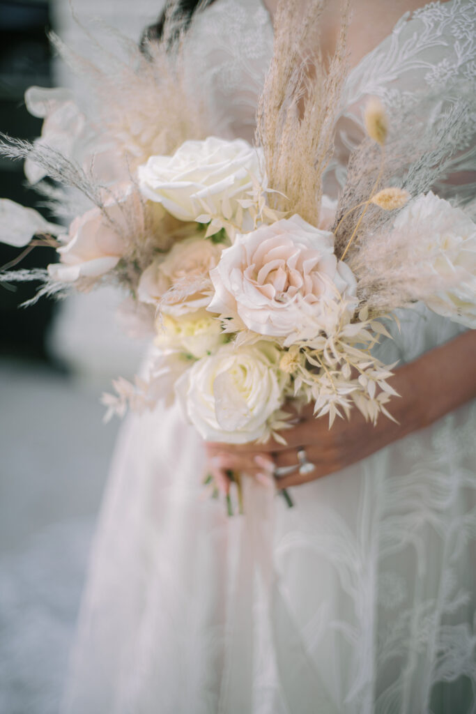 Bridal bouquet of full blush and white roeses, pampas, dried bunny tails, and dried lunaria.