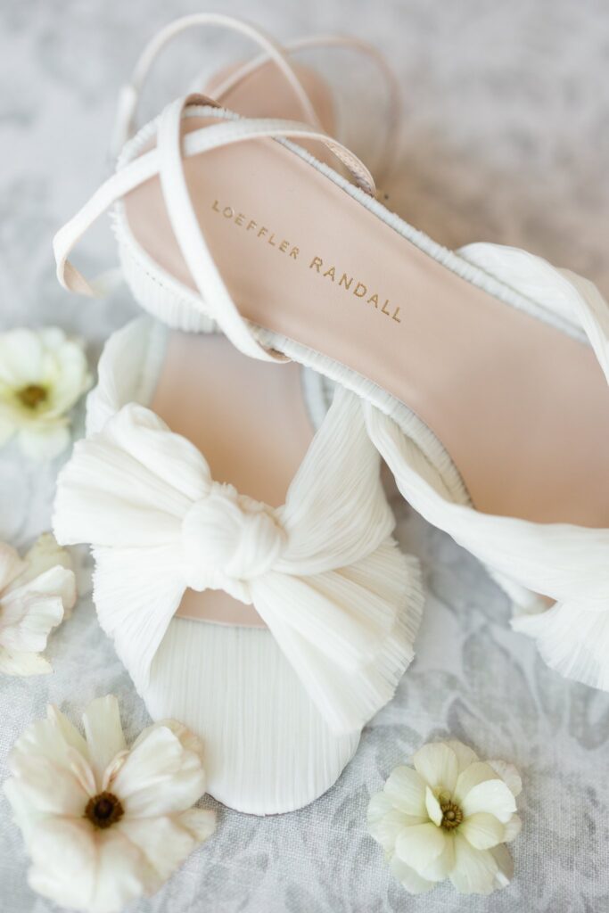 White bridal shoes with bows.