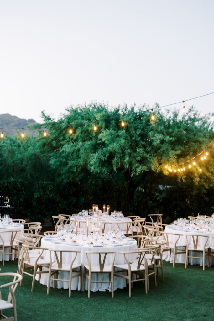 Outdoor reception table settings with candles and floral centerpieces at Sanctuary Resort.