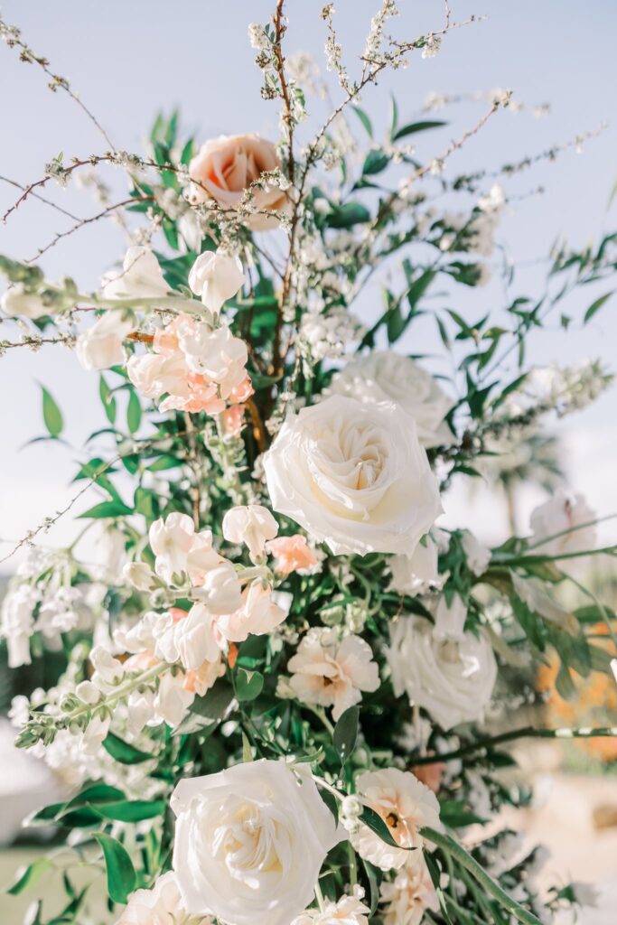White and blush roses and greenery wedding floral.