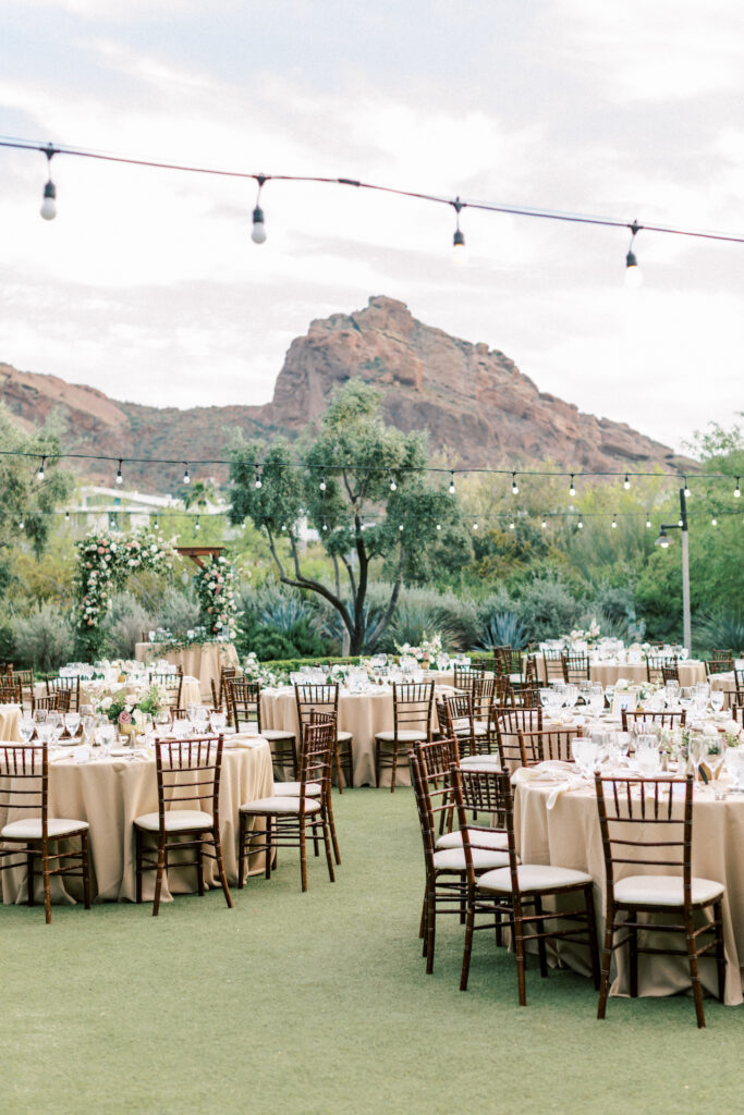Outdoor wedding reception with round tables at El Chorro with desert views in background.