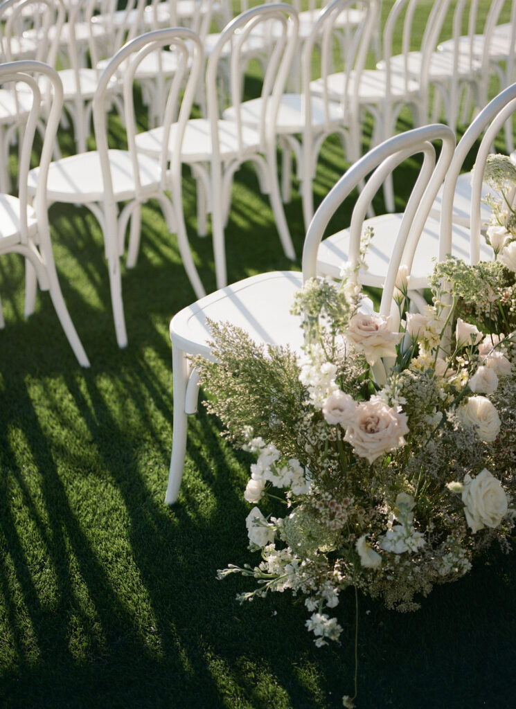 Back of aisle ground floral arrangements in white and blush.