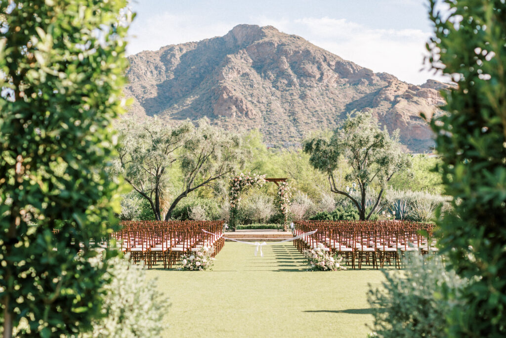 Outdoor wedding ceremony at El Chorro with desert mountain views in background.