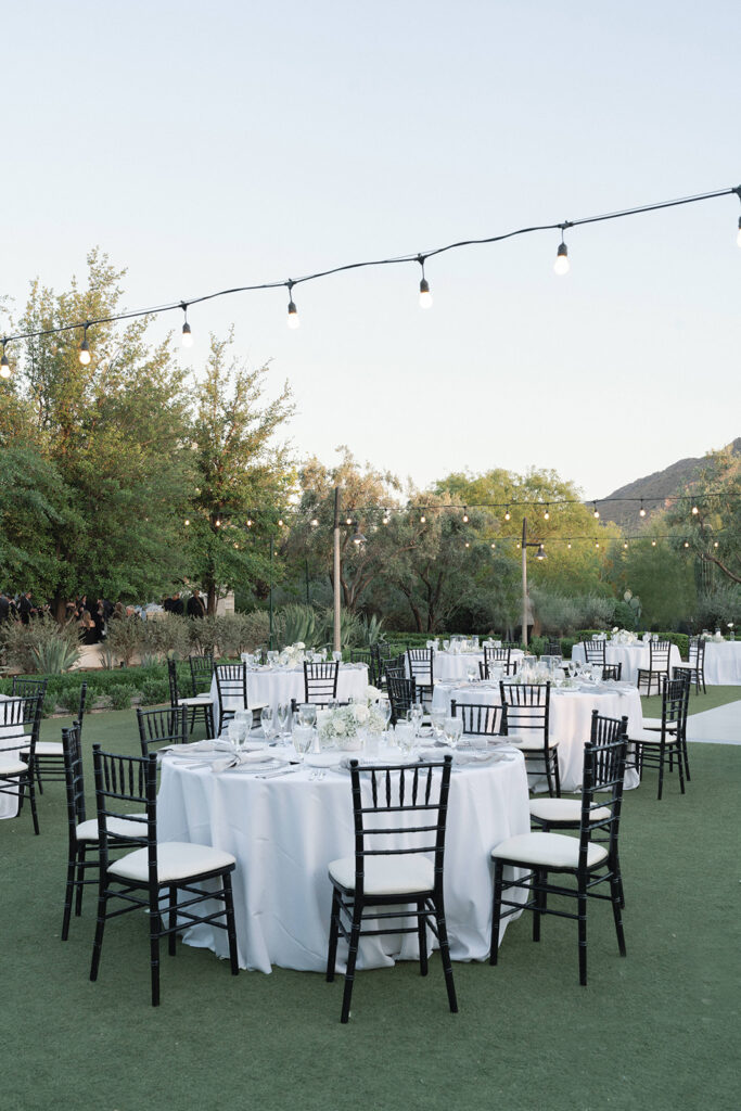 Outdoor wedding reception at El Chorro with white linens on round tables.