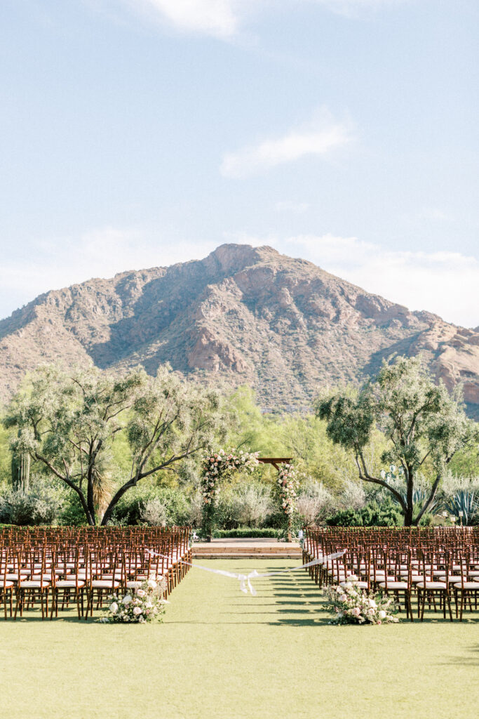 Outdoor wedding ceremony at El Chorro with desert mountain views in background.