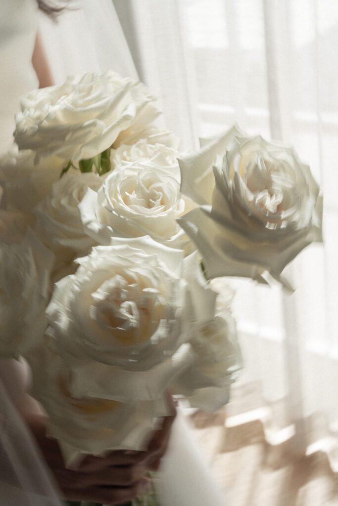 White roses with long stems bridal bouquet.