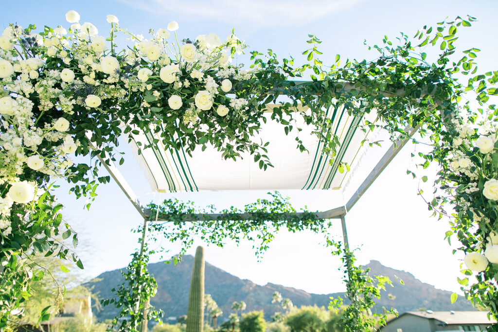 Floral installation on wedding ceremony chuppah of white flowers and greenery at Mountain Shadows.