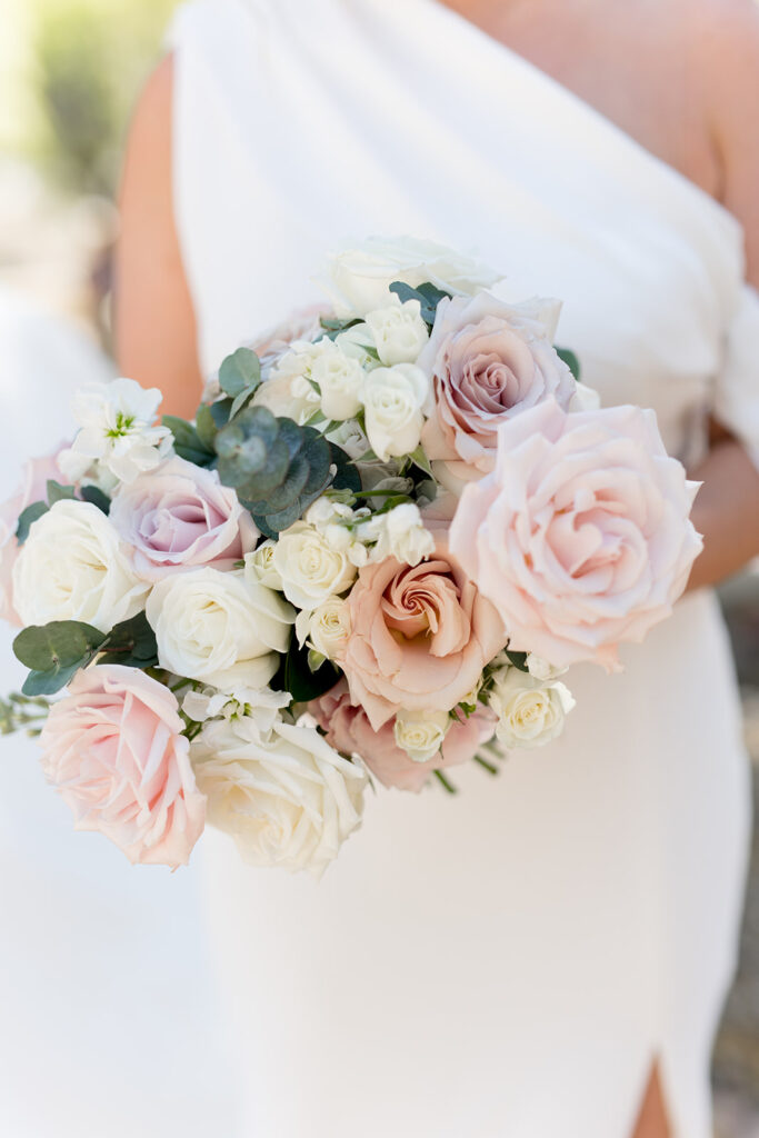 Bridal bouquet of roses in blush and white and spiral eucalyptus.