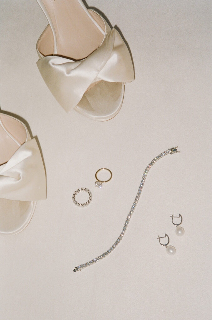Bridal shoes, rings, diamond bracelet and pearl earrings.