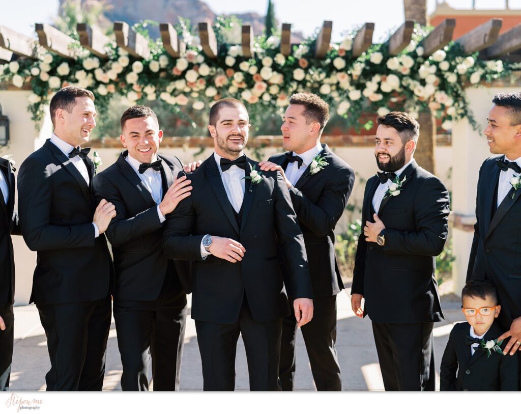 Groom with groomsmen in black suits.