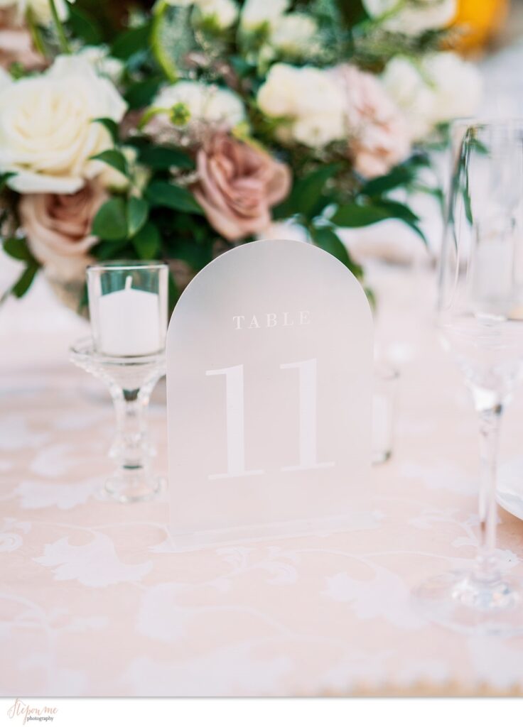 Frosted table number sign for wedding reception.