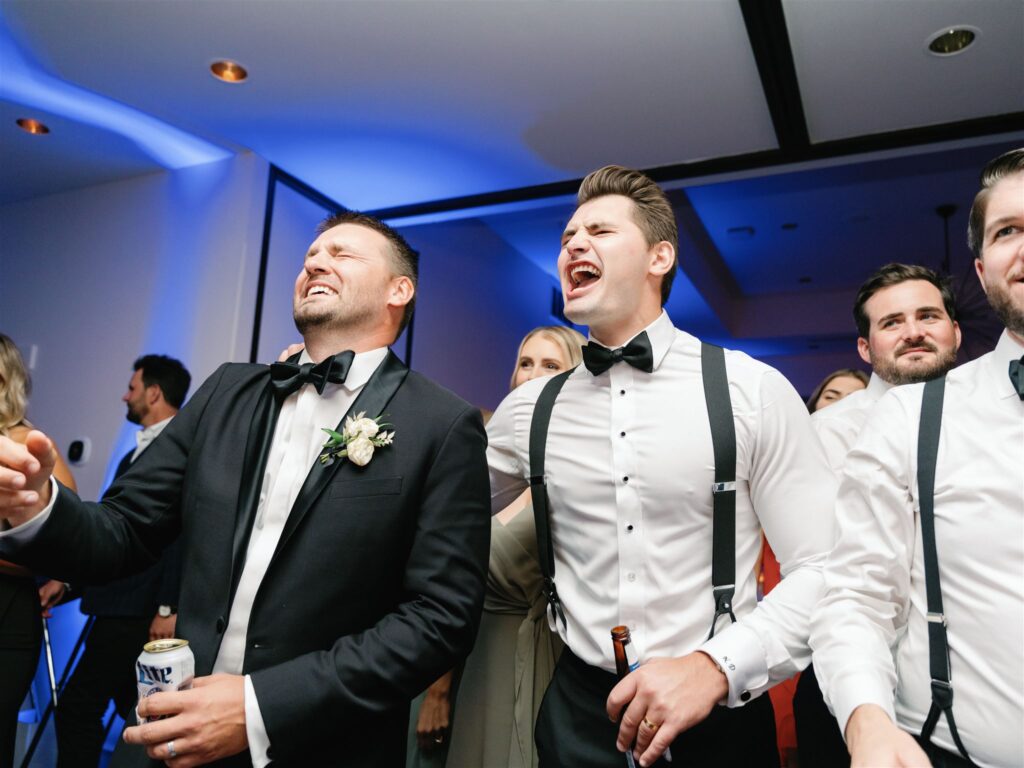 Groom and groomsmen rocking out to live band