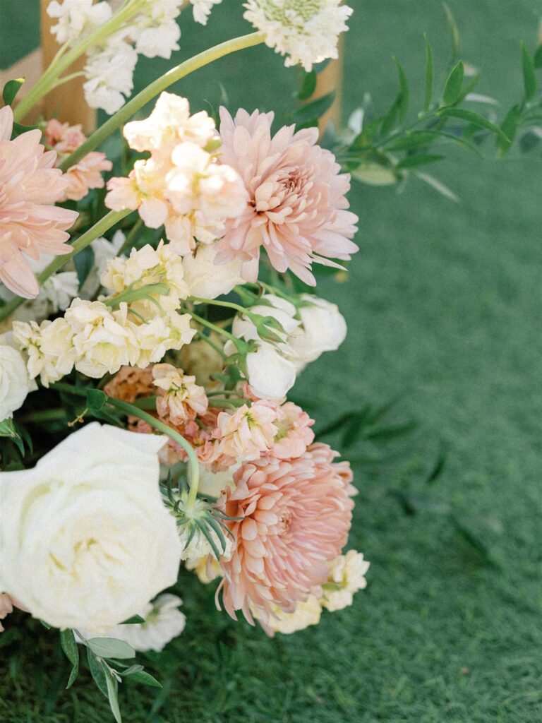 Detail image of wedding flowers of pink and white with greenery.