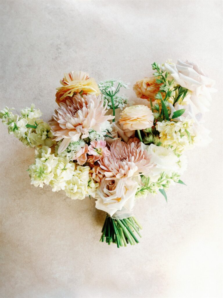 Bridal bouquet of pink, orange, and white flowers.