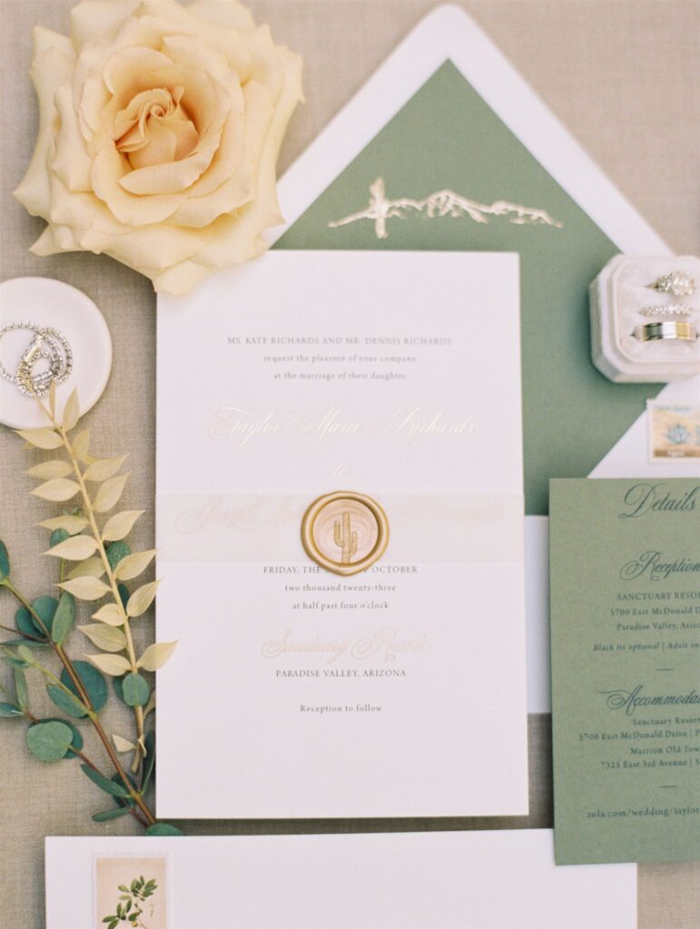 Wedding invitation of white and sage green with desert details.