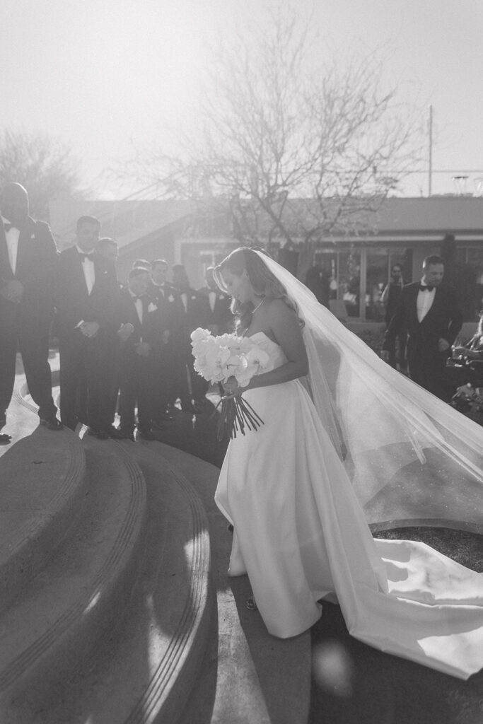 Bride and groom ascending stairs to wedding ceremony altar space at Mountain Shadows.