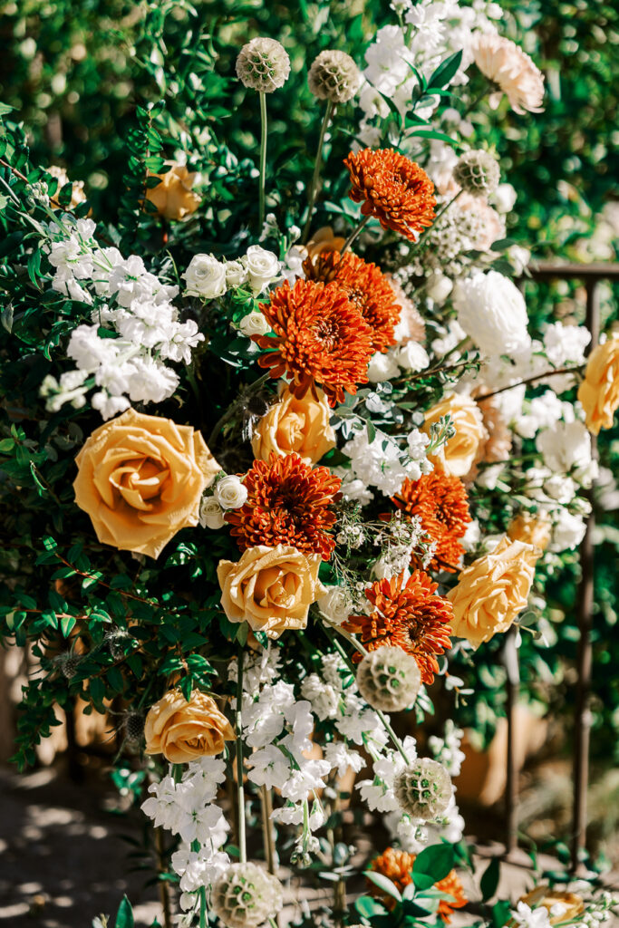 Orange, gold, and white flowers for wedding design.