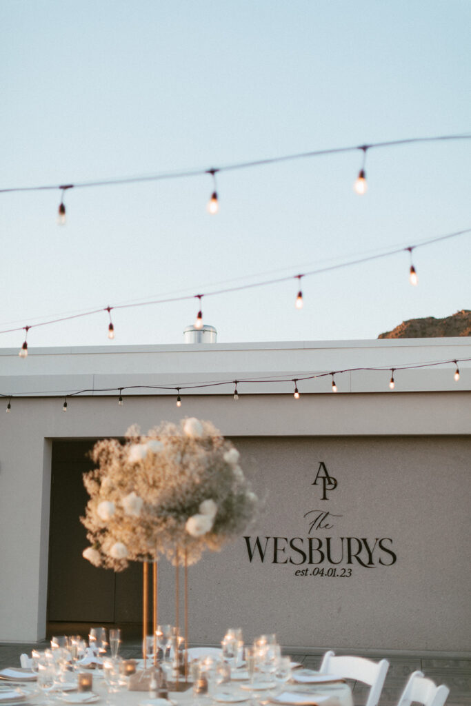 Outdoor custom wedding reception sign of couple's name added to wall.