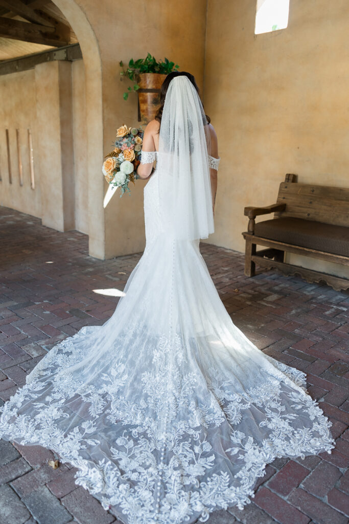 Back of bride's gown and veil showing details of the design.