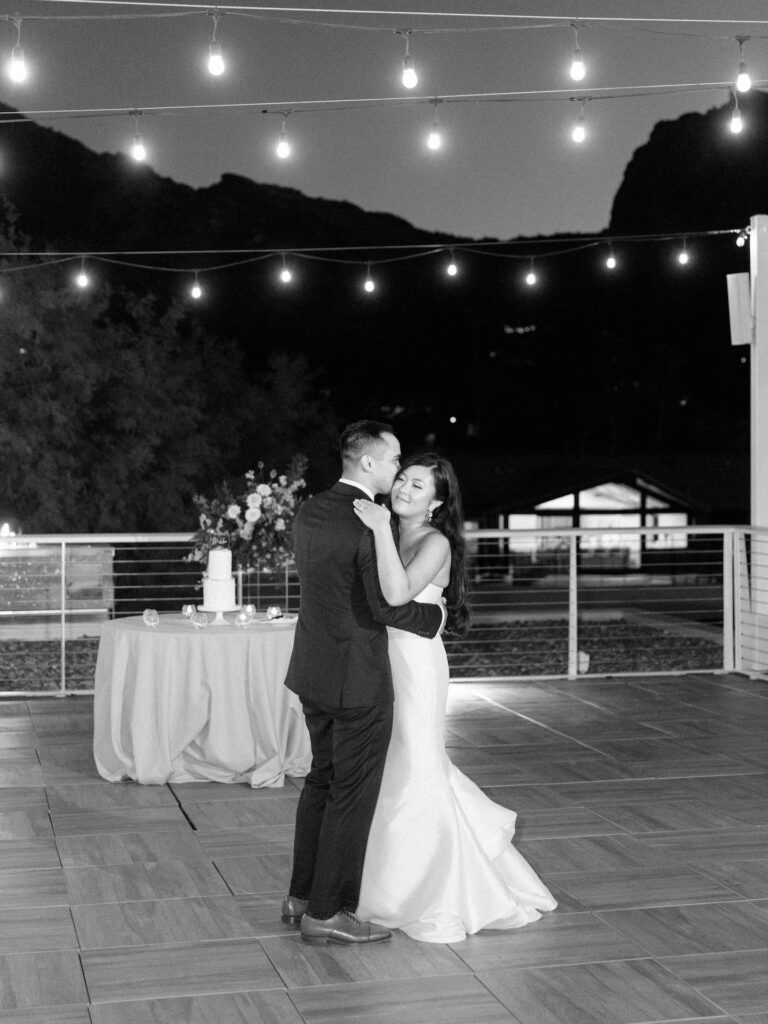 Bride and groom dancing together during wedding reception.