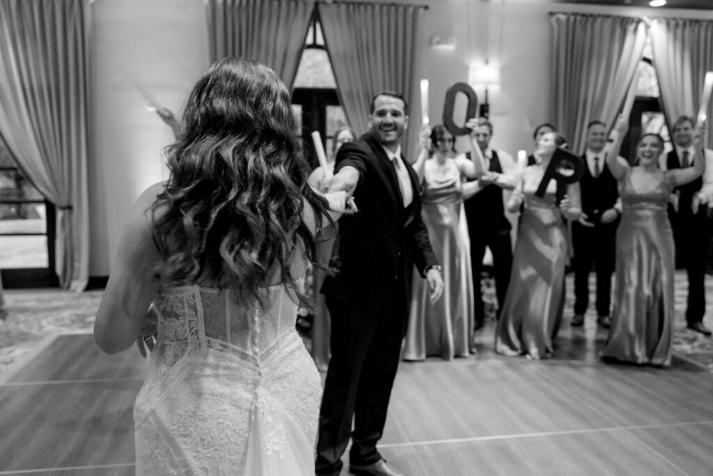 Bride and groom dancing at indoor wedding reception.