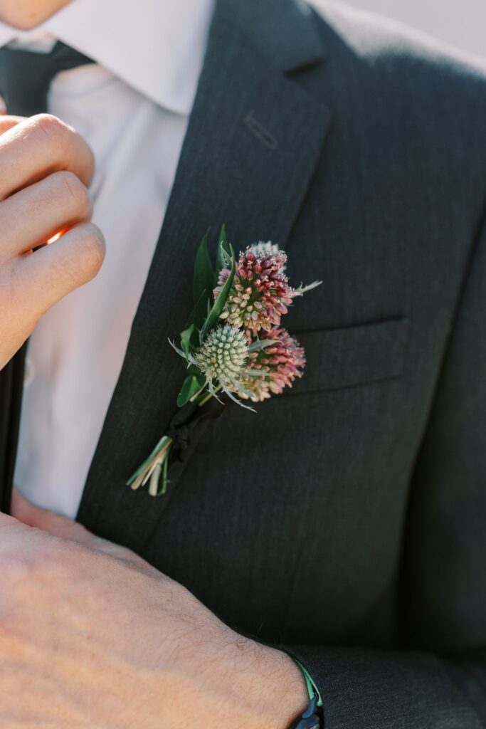 Groom boutonniere of thistle and greenery.