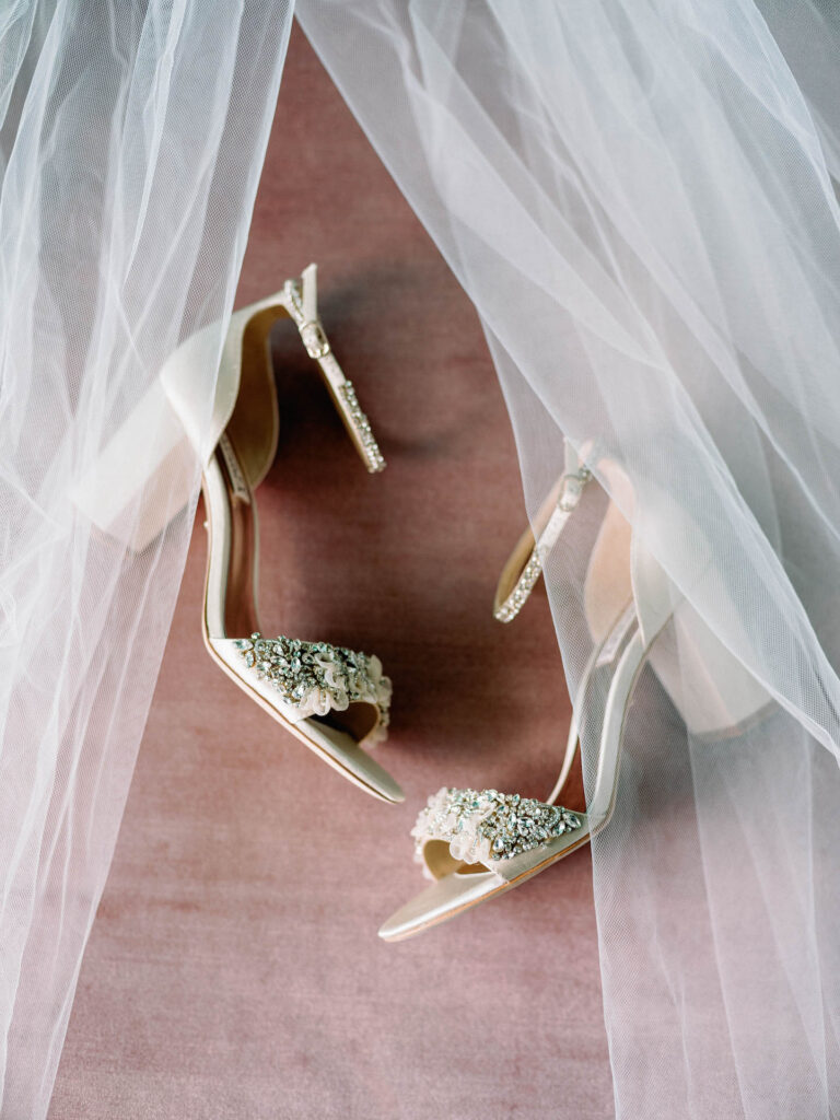 Bridal shoes framed by bridal veil.