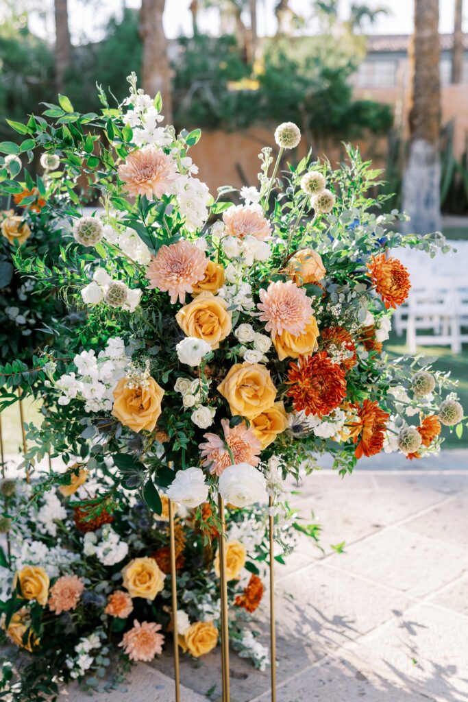 Wedding ceremony floral arrangements in pink, white, gold and greenery.