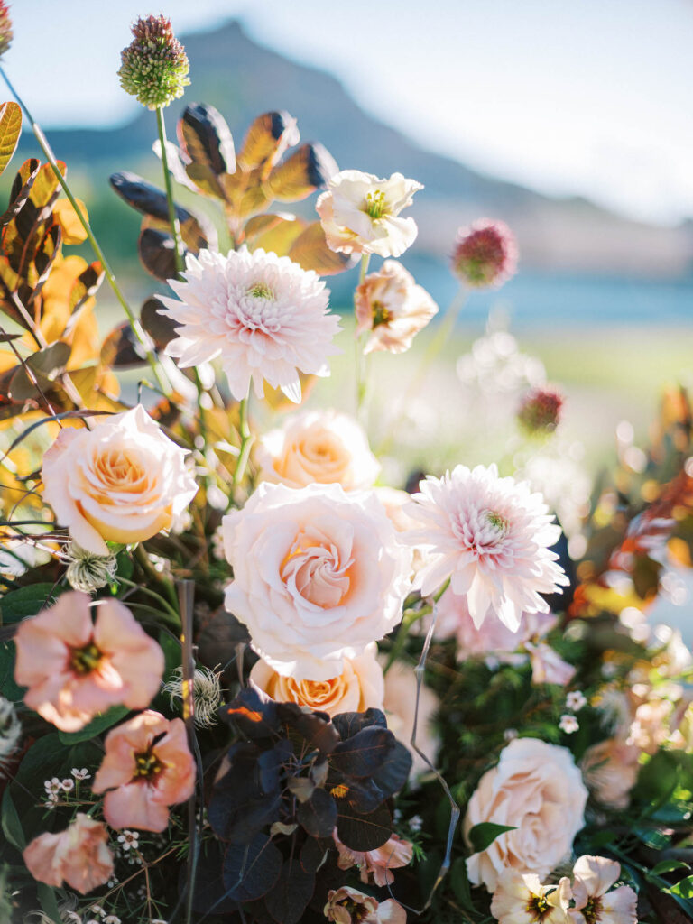 Detail image of wedding flowers in pink with dark greenery.