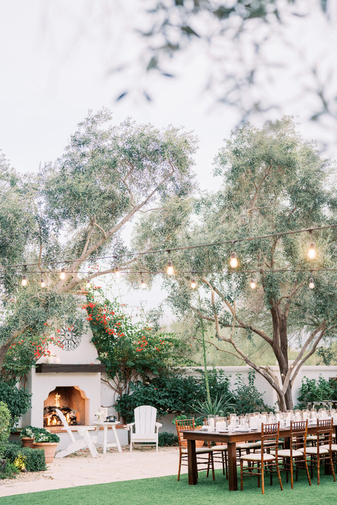 Outdoor wedding reception space near fireplace at Royal Palms resort.