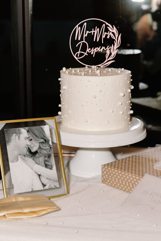 Single tier wedding cake with pearl accents added.