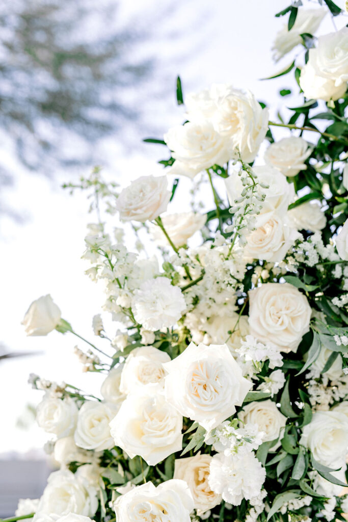 White wedding flowers from on wedding ceremony arch.