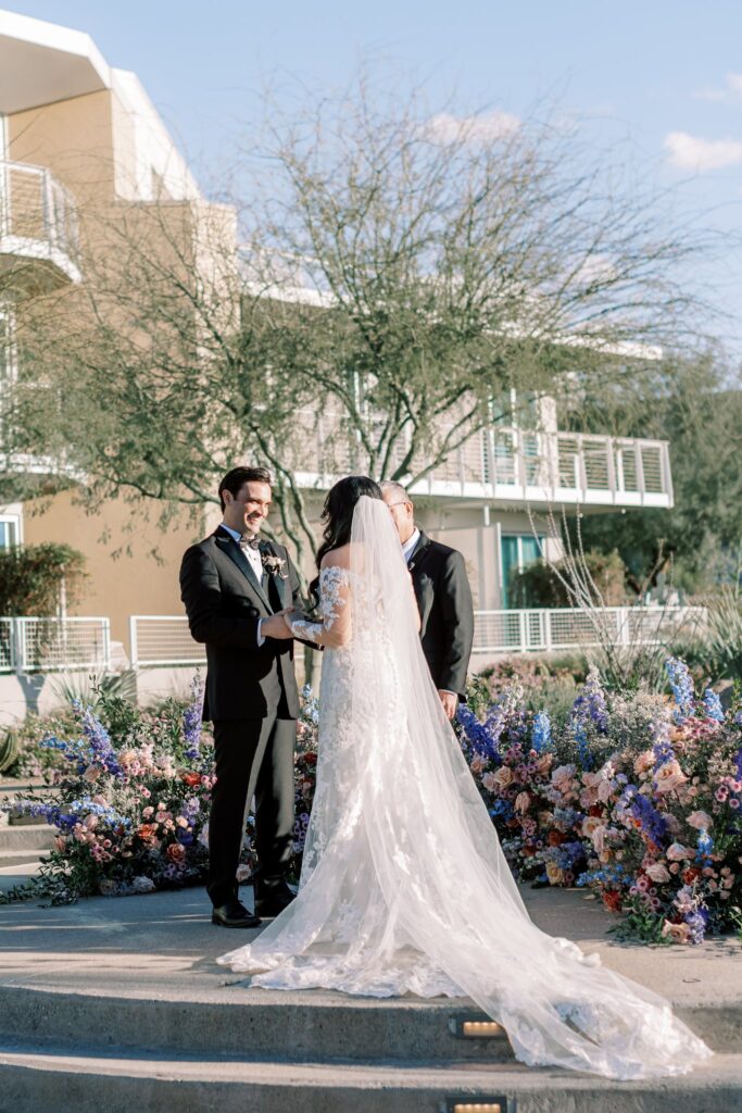 Bride and groom in wedding altar space with officiant.