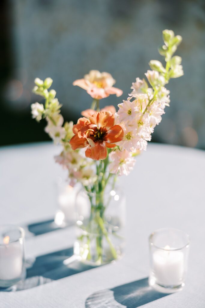 Dark pink and and blush pink flowers in glass bud vase,