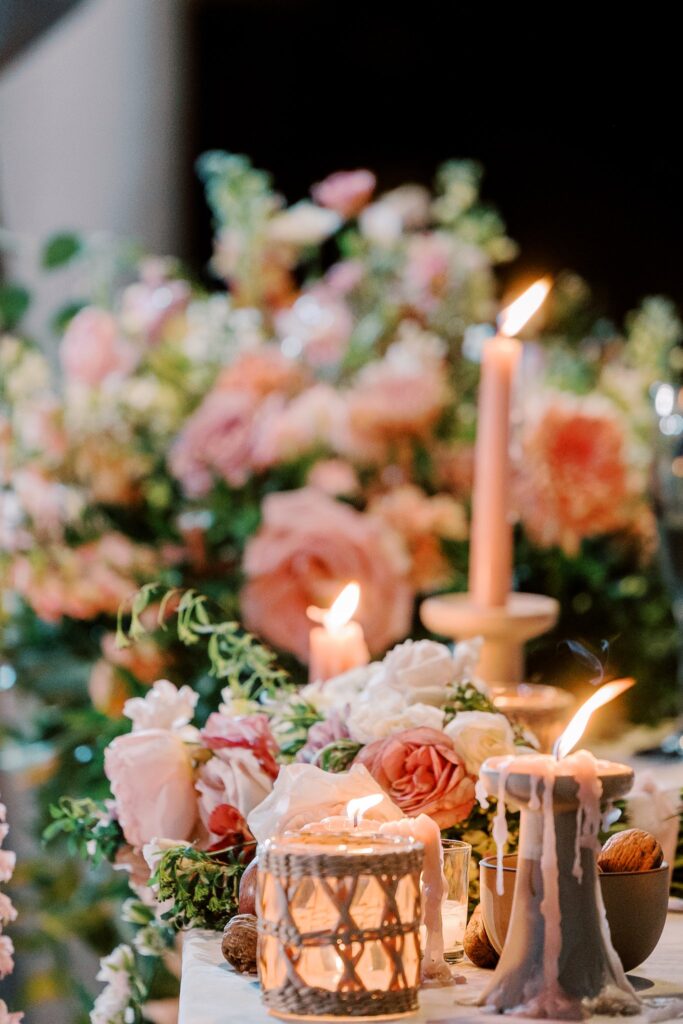 Wedding flowers and melted pink taper candles.