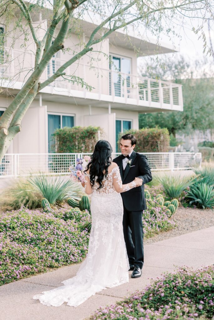 Bride and groom meeting on path at Mountain Shadows , holding hands.