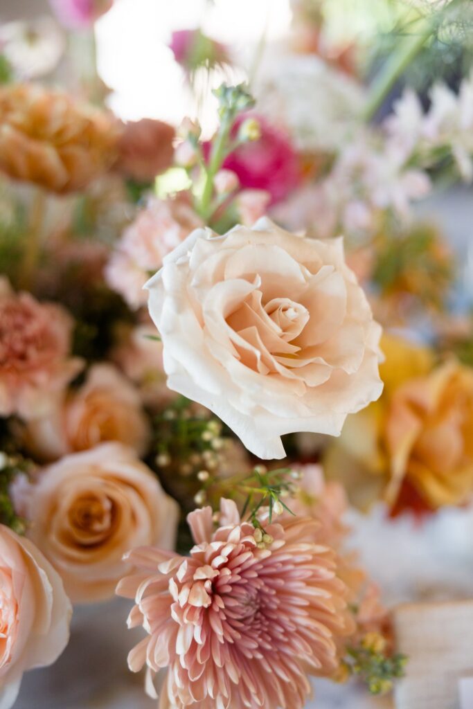 Close of image of pink flowers in wedding flower arrangement.