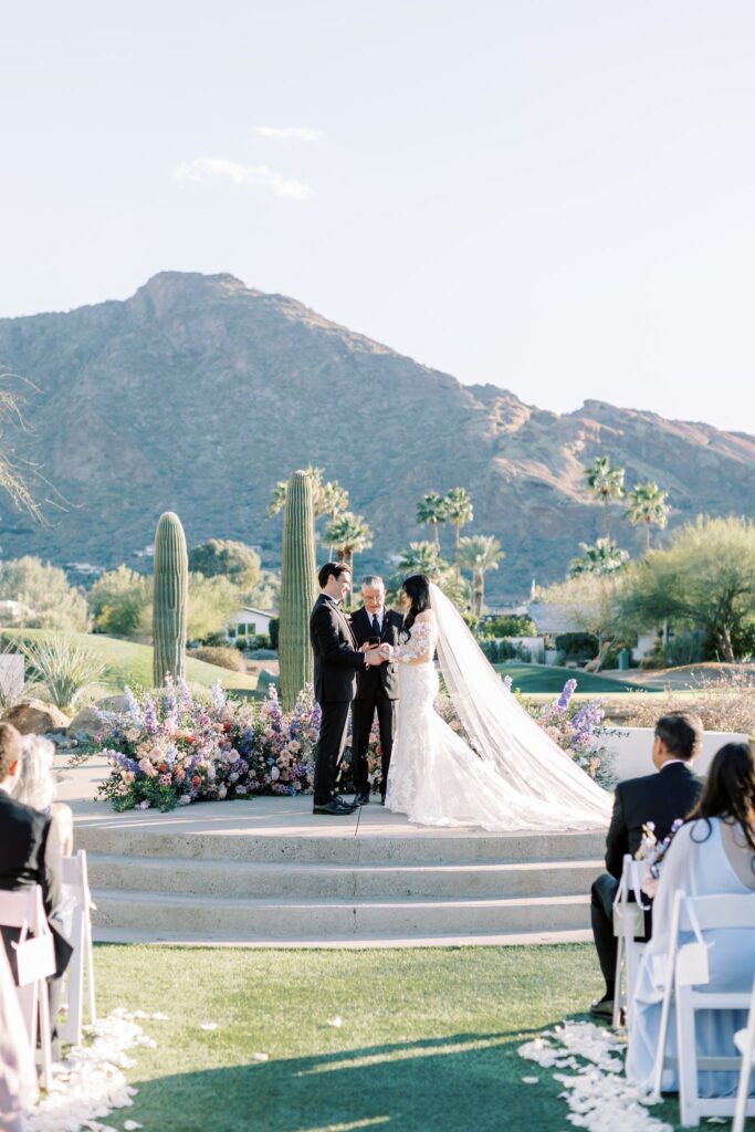 Bride and groom in wedding altar space with officiant.