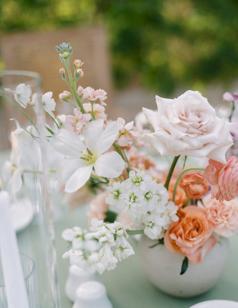 Romantic and delicate wedding flower centerpiece of shades of pink and white flowers.