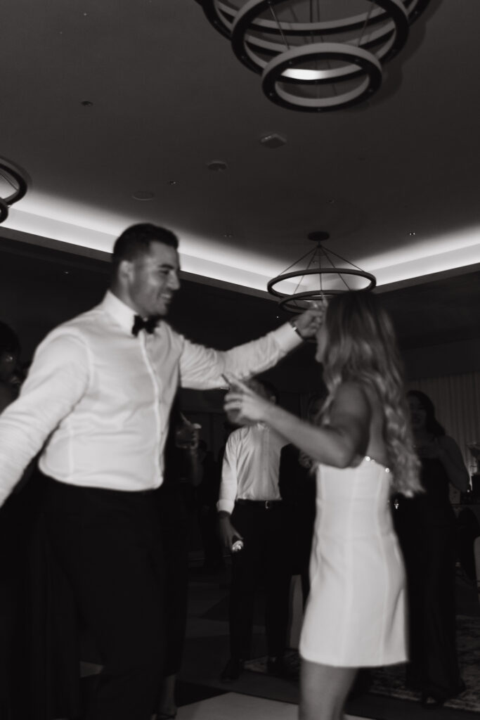 Bride and groom dancing at indoor reception.