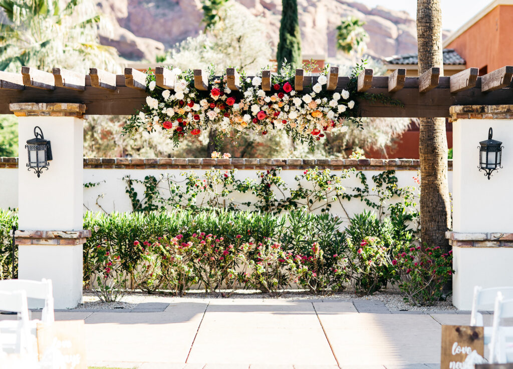 Omni Montelucia pergola decorated with flowers for wedding ceremony.