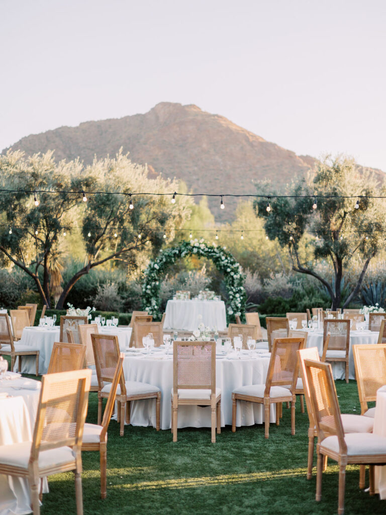 Outdoor reception with round tables at El Chorro with Camelback Mountain in the background.