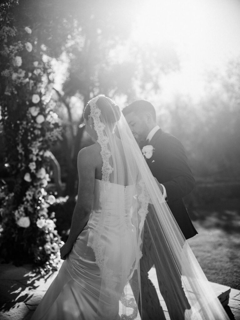 Groom helping bride up stairs to altar space during wedding cermeony.